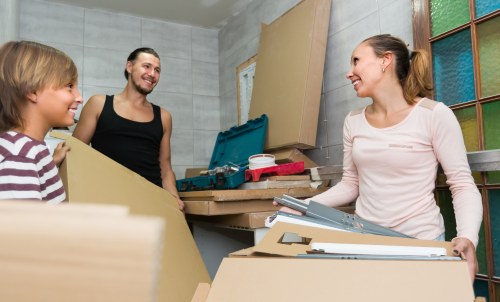 Moving team loading household items into a van