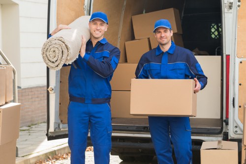 Movers carrying furniture during an urgent relocation in Harrow