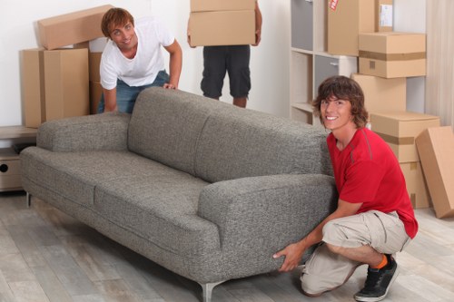 Local movers handling furniture in a Harrow street